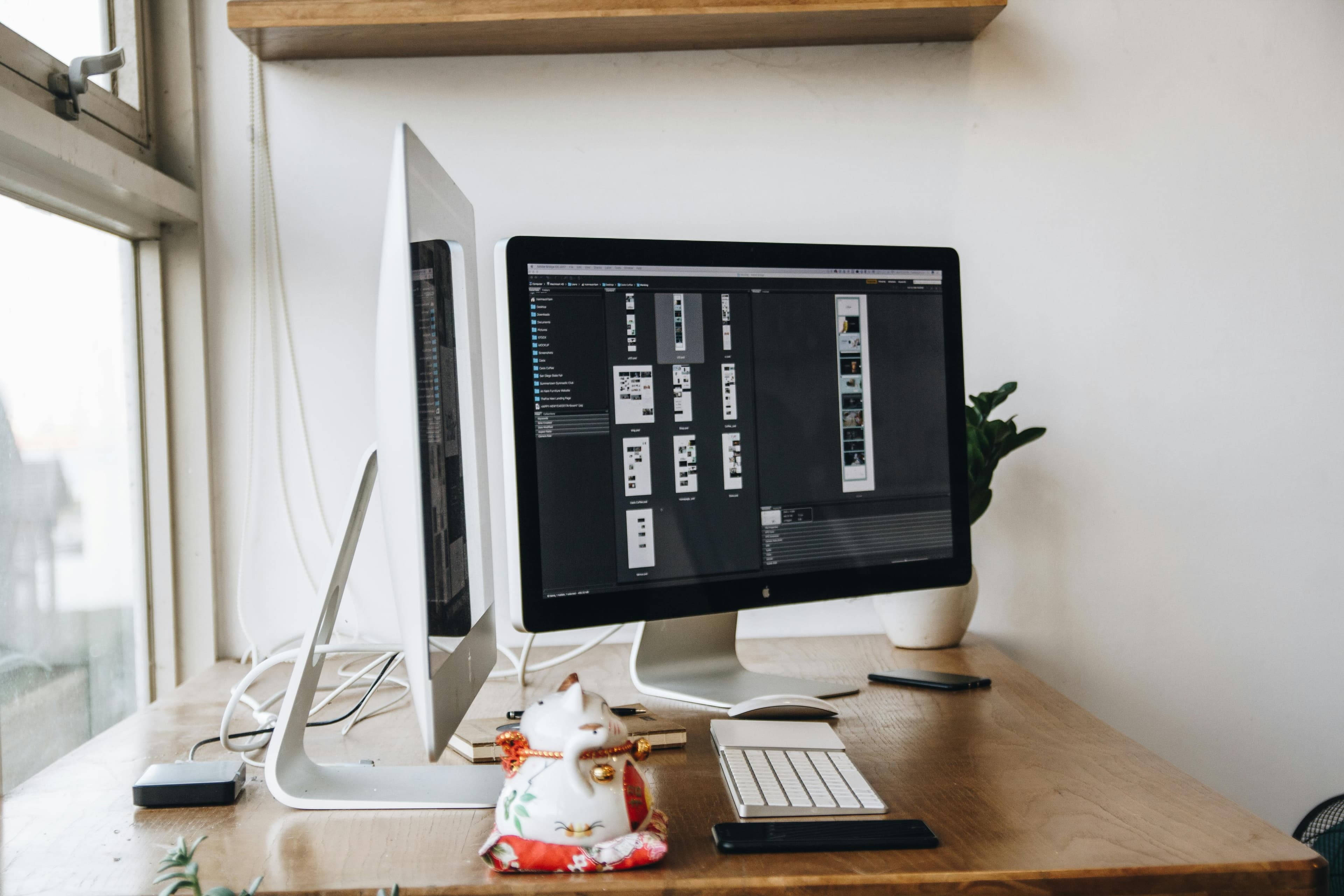 A desktop computer in a clean workspace beside a window.